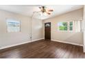 Inviting living room with wood-look flooring, a ceiling fan, and two windows for ample natural light at 1103 Timor Ave, Orlando, FL 32804