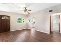 Comfortable living room with wood-look flooring, ceiling fan, natural light, and access to the bathroom at 1103 Timor Ave, Orlando, FL 32804