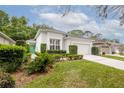 Charming single-story home with manicured landscaping, lush green lawn, and a bright green front door at 113 Golden Crest Ct, Winter Springs, FL 32708