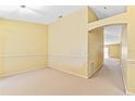 Spacious room featuring neutral carpet, paint, and arched doorway at 1234 1St Ave, Deland, FL 32724