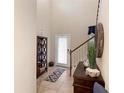Elegant foyer with high ceilings, a tiled floor, and a staircase at 1304 Independence Ln, Mount Dora, FL 32757