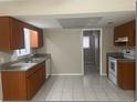 Functional kitchen featuring tiled floors, ample cabinet space, and a view into the next room at 1415 Meadowlark St, Longwood, FL 32750