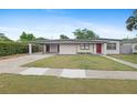 Charming single-story home with a well-maintained lawn, carport, and freshly painted exterior at 1633 Colton, Orlando, FL 32822