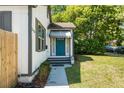 Home's entry featuring a beautiful turquoise door and tasteful landscaping at 1638 Mount Vernon St, Orlando, FL 32803