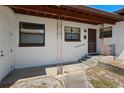 A covered front porch with ornate metal supports and a pathway to the side door at 1807 Yorkshire Dr, Winter Park, FL 32792