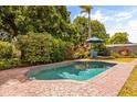 Inviting backyard pool with a brick patio and lush landscaping, perfect for relaxation and entertainment at 2508 Osage Trl, Fern Park, FL 32730