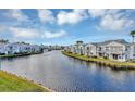 Beautiful waterfront community featuring a canal with fountain, blue skies, and well-manicured lawns at 2568 Woodgate Blvd # 204, Orlando, FL 32822