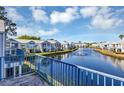 Waterfront condos overlooking canal, blue railings, with fountain and blue skies at 2568 Woodgate Blvd # 204, Orlando, FL 32822