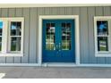 Close-up of a blue double-door entrance framed by white trim and matching windows at 311 W Delaware Ave, Lake Helen, FL 32744