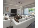 Bright living room showcases white sofas, contemporary decor, and expansive sliding glass doors at 311 W Delaware Ave, Lake Helen, FL 32744