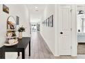 Hallway with wood-look floors, decorative table, and decor at 312 Inman Blvd, Winter Haven, FL 33881