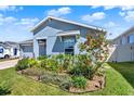 Professionally landscaped front yard featuring vibrant plants and exterior lighting at 312 Inman Blvd, Winter Haven, FL 33881