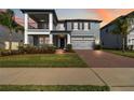 Beautiful two-story home with manicured lawn, paver driveway, and inviting curb appeal at 3121 Buffington Pl, Oviedo, FL 32765