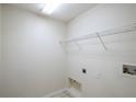 Functional laundry room featuring a wire shelf, utility connections, and neutral-toned walls at 3199 Quail Dr, Deltona, FL 32738