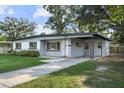 Welcoming single-story home with a lush green lawn and a convenient covered carport, providing ample parking at 3214 Debbie Dr, Orlando, FL 32806
