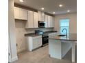 Modern kitchen with white cabinets, stainless steel appliances, granite countertops, and a center island at 4152 Sagefield Dr, Harmony, FL 34773
