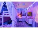Themed bedroom featuring unique lighting, a bunk bed with white curtains and a Disney themed wall at 4210 Lana Ave, Davenport, FL 33897