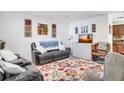 Cozy living room features comfortable seating, a floral rug, and decorative wall art at 4482 Se 142Nd St, Summerfield, FL 34491