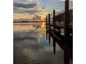 Picturesque waterfront view from a wooden dock at sunset, showcasing serene water reflections at 4672 Marina Row Dr, Orlando, FL 32820