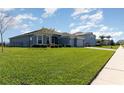 Beautifully landscaped front yard with lush green grass and neatly trimmed bushes enhancing curb appeal at 4672 Marina Row Dr, Orlando, FL 32820