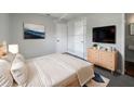 Serene main bedroom featuring a soothing color scheme, ample closet space, and television at 5618 Carris Ct, Orlando, FL 32810