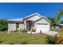 Charming single-story home featuring a manicured lawn, two-car garage and neutral-toned exterior at 5694 Aragon Ave, De Leon Springs, FL 32130