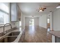 Spacious open-concept living room and kitchen area featuring modern finishes and ample natural light at 5694 Aragon Ave, De Leon Springs, FL 32130