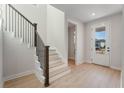 Bright entryway with wood floors, staircase, and a modern front door with glass panels at 6525 Rover Way, St Cloud, FL 34771