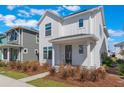 Stylish two-story home boasting a white exterior and neatly landscaped front yard at 6525 Rover Way, St Cloud, FL 34771