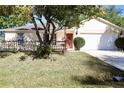 Inviting single-Gathering home featuring a spacious front yard and an attached two-car garage at 7 Sequoia Way, Kissimmee, FL 34758