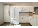 Bright kitchen featuring white cabinets, modern appliances, and ample counter space at 7 Sequoia Way, Kissimmee, FL 34758