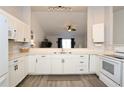 Bright kitchen with white cabinetry, modern appliances, and stylish backsplash at 7 Sequoia Way, Kissimmee, FL 34758