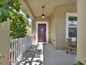 Inviting front porch with a decorative door, hanging light fixture, and a cozy seating area at 7945 Pleasant Pine Cir, Winter Park, FL 32792