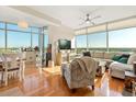 Bright living room featuring large windows, hardwood floors, and elegant furnishings at 101 S Eola Dr # 902, Orlando, FL 32801