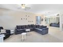 Bright living room with a large sectional sofa, neutral walls, and ample natural light at 14230 Sunriver Ave, Orlando, FL 32828