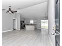 Open-concept kitchen with granite countertops, stainless steel appliances, and gray cabinets at 14978 Sw 24Th Cir, Ocala, FL 34473
