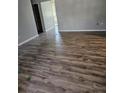 Spacious living room featuring wood-look flooring, neutral walls, and plenty of natural light at 1510 Massa St, Kissimmee, FL 34744