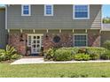 Close up of home's entrance with a brick facade and manicured front garden at 1621 Chippewa Trl, Maitland, FL 32751