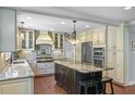 A spacious kitchen with granite counters, island, and modern stainless steel appliances at 1621 Chippewa Trl, Maitland, FL 32751
