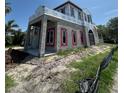 Exterior view of the framing construction, including windows, of a two story house, with mud and grass in the front at 1803 Florinda Dr, Orlando, FL 32804