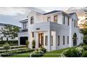 Beautiful two-story home with white brick facade, black trim, and manicured front yard at 1803 Florinda Dr, Orlando, FL 32804