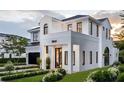 Stunning two-story home boasts modern architecture, a manicured lawn, and elegant black-framed windows at 1803 Florinda Dr, Orlando, FL 32804
