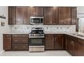 Modern kitchen features stainless steel appliances and backsplash at 193 Old Moss Cir, Deland, FL 32724