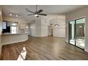 Open-concept living room featuring modern lighting, and stylish wood-look floors at 213 Almaden Ct, Winter Springs, FL 32708