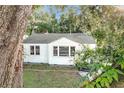 Charming one-story house featuring white siding and a classic design with lush trees surrounding at 2509 Formosa Ave, Orlando, FL 32804