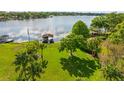 Spacious backyard with lush lawn, mature trees, and waterfront access with a private dock at 2922 Carmia Dr, Orlando, FL 32806