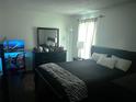 Inviting primary bedroom featuring soft natural light, black furniture and a zebra throw blanket at 4251 Pinebark Ave # 17-3, Orlando, FL 32811
