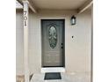 The house features a gray front door with decorative glass, modern lighting and the house number, 701 at 701 N 4Th St, Haines City, FL 33844