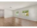 Bright living room with wood-look flooring and natural light from the multiple windows at 704 Briarwood Dr, Winter Springs, FL 32708