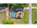 Top-down aerial view showcasing a home with a screened pool and solar panels in a country setting at 8499 Se 155Th, Summerfield, FL 34491